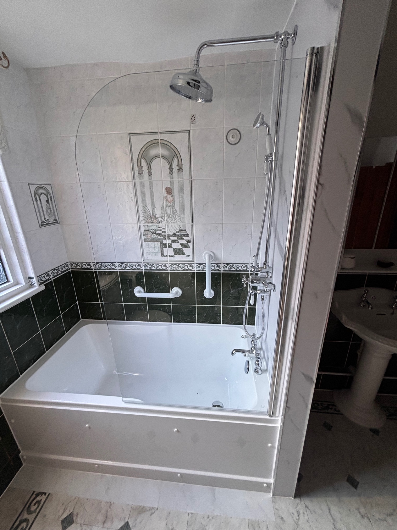 Bath with traditional chrome pillar taps and shower screen