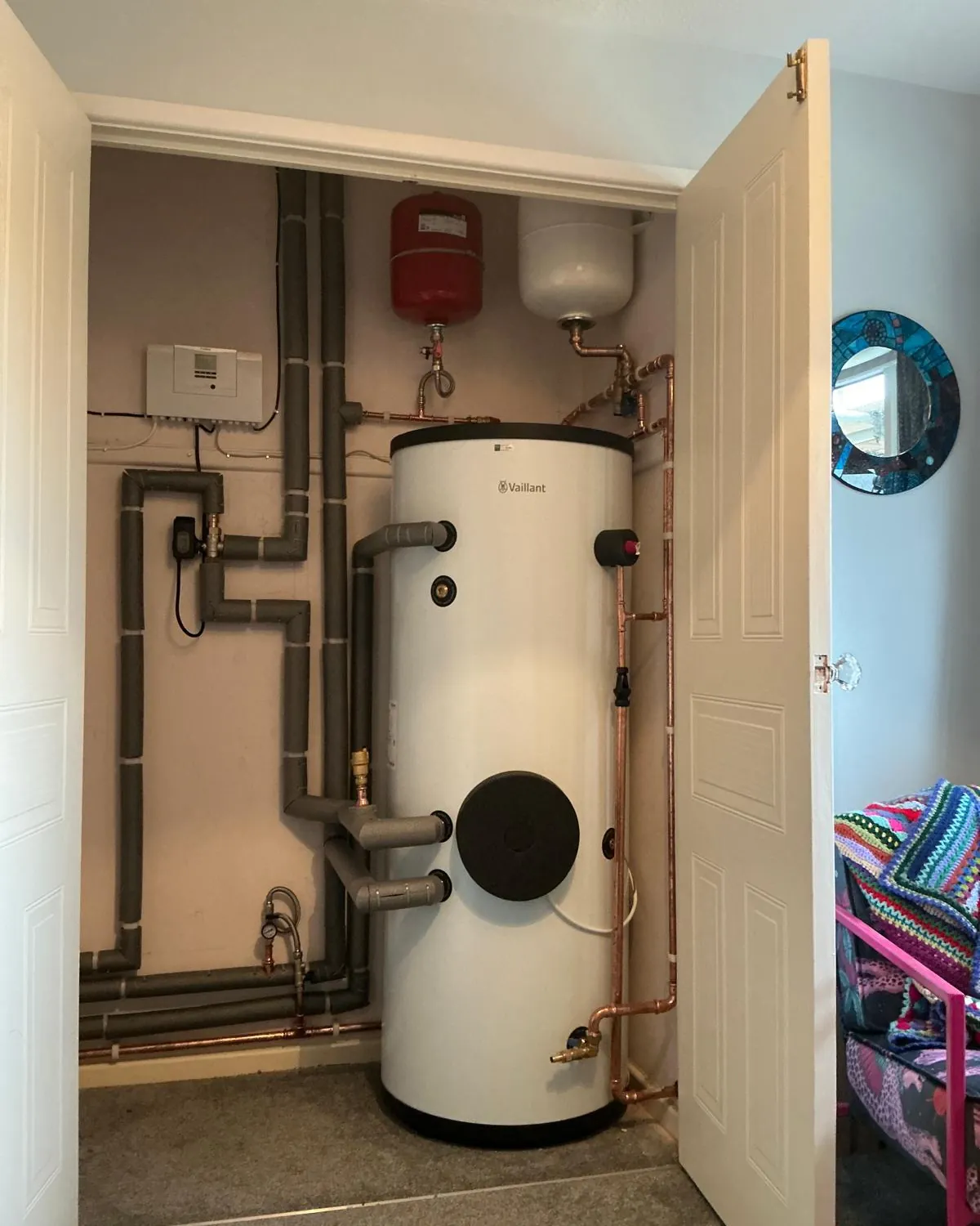 Vaillant unvented hot water cylinder installed in an airing cupboard