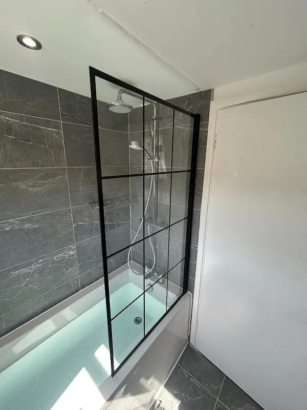 New bath with black framed glass shower screen, seen from above