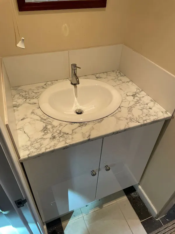 New vanity unit with marble-effect worktop and inset basin