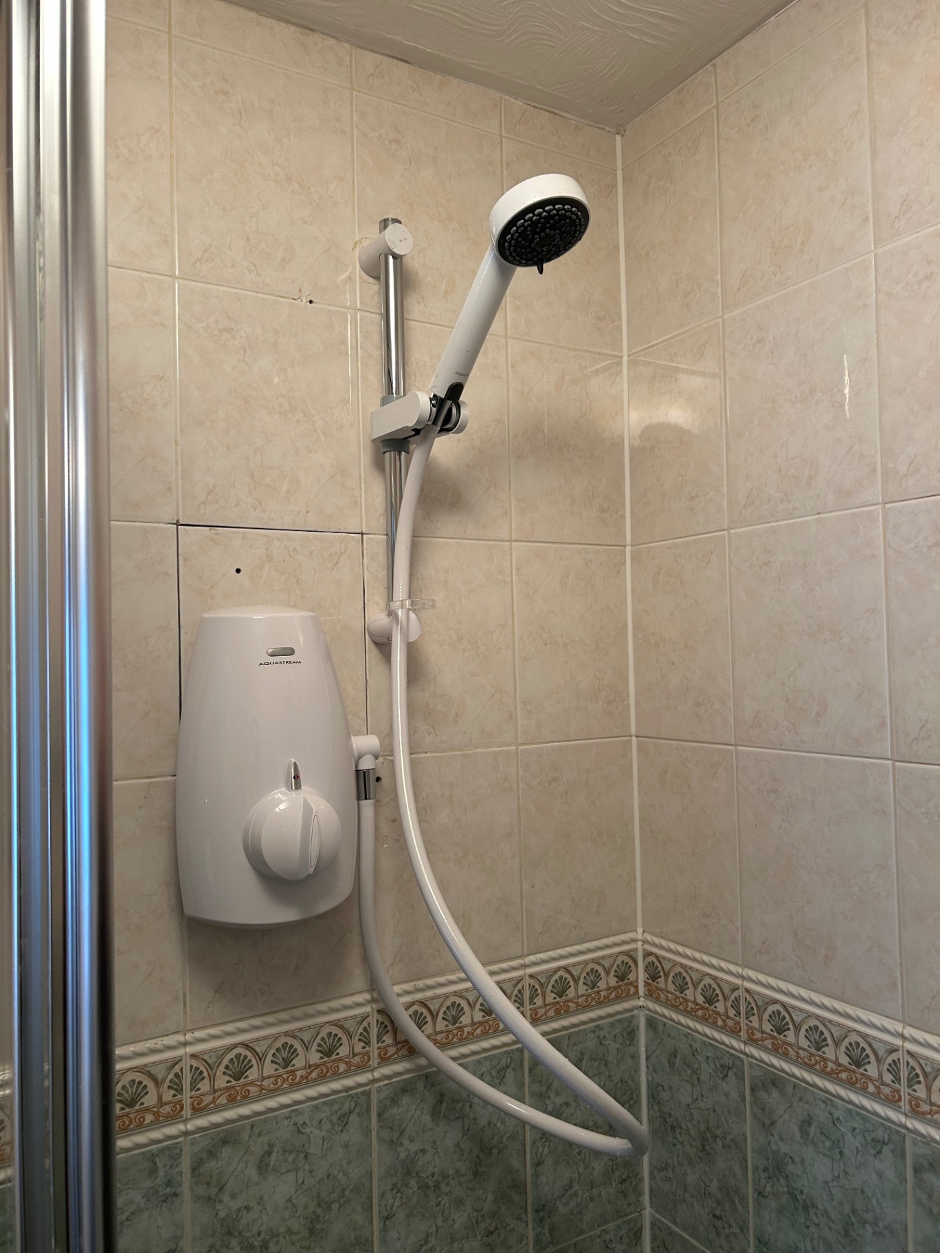 New electric shower fitted with riser rail and handset