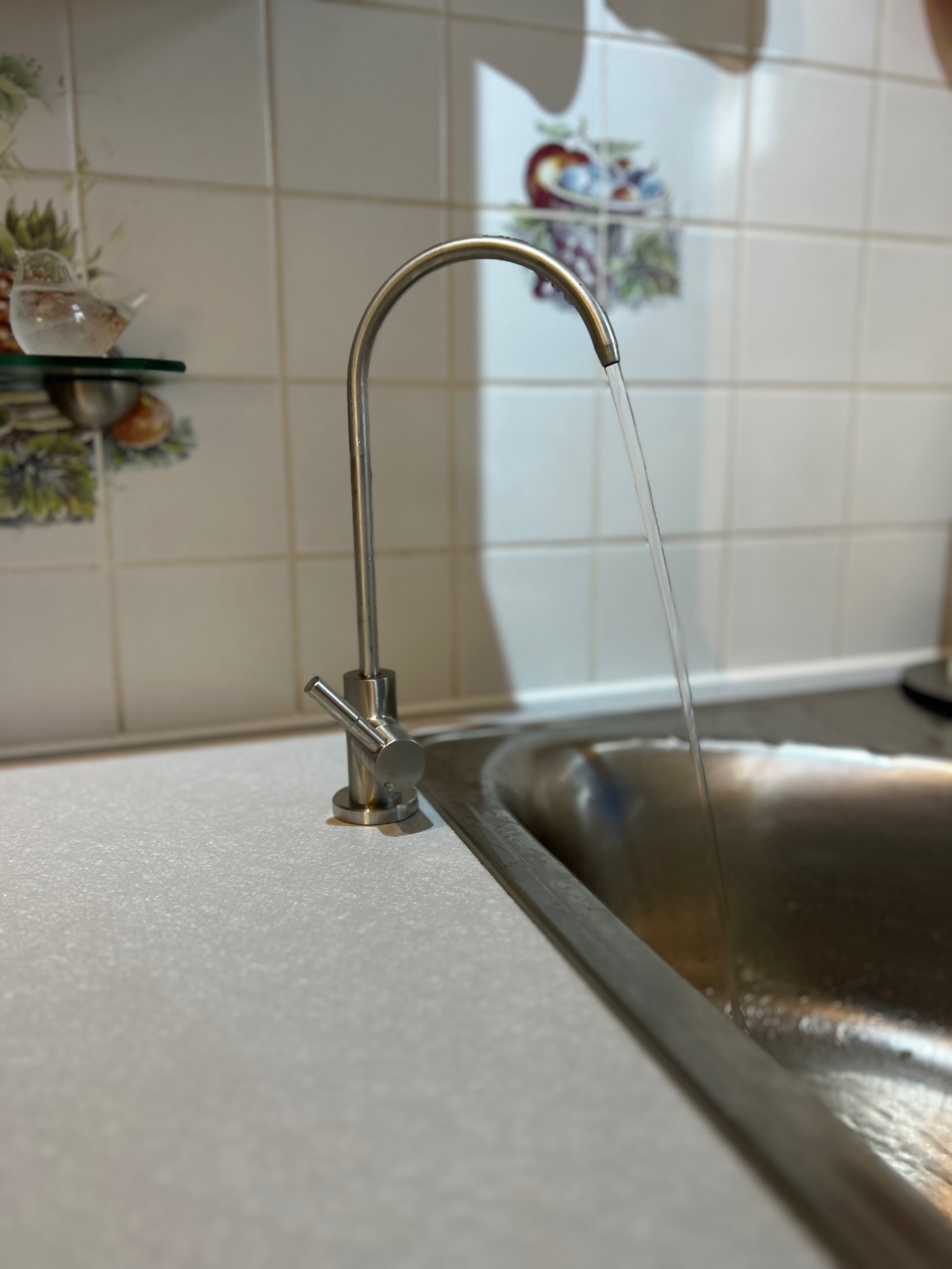 New brushed stainless steel filtered water tap over a kitchen sink