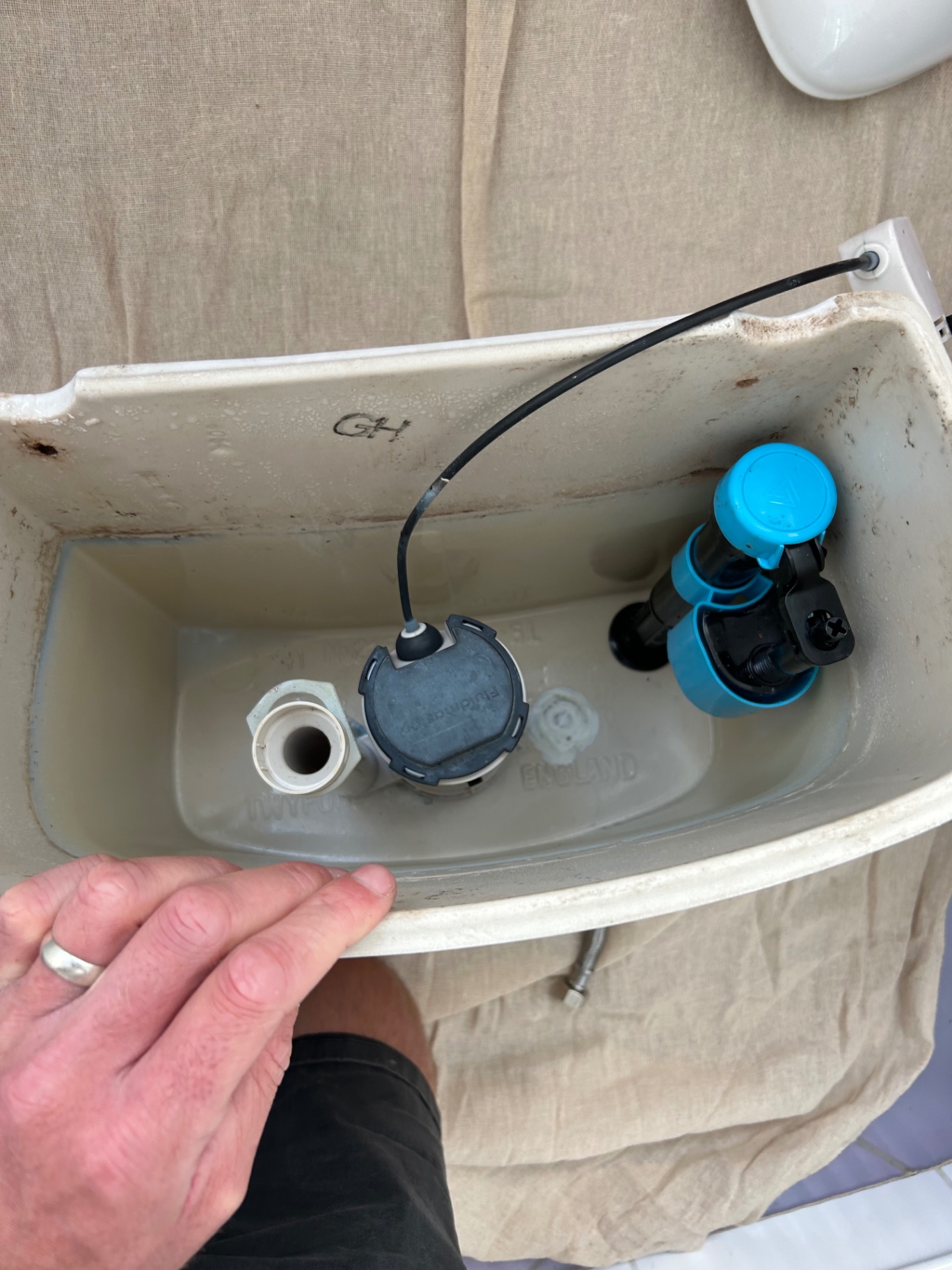 New fill and flush valves fitted inside a toilet cistern