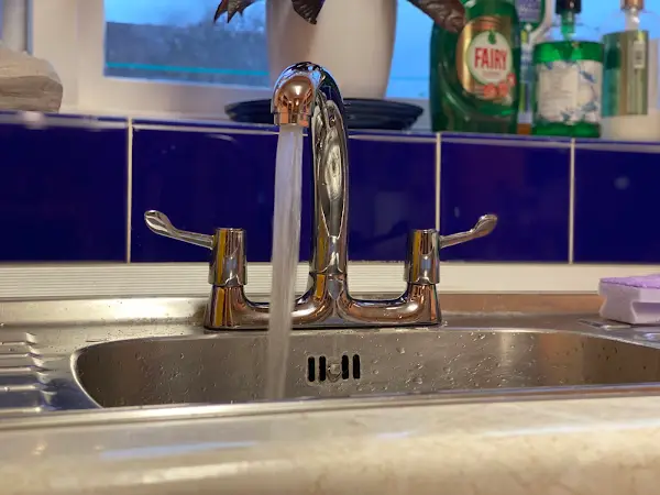Replacement chrome kitchen tap with water running