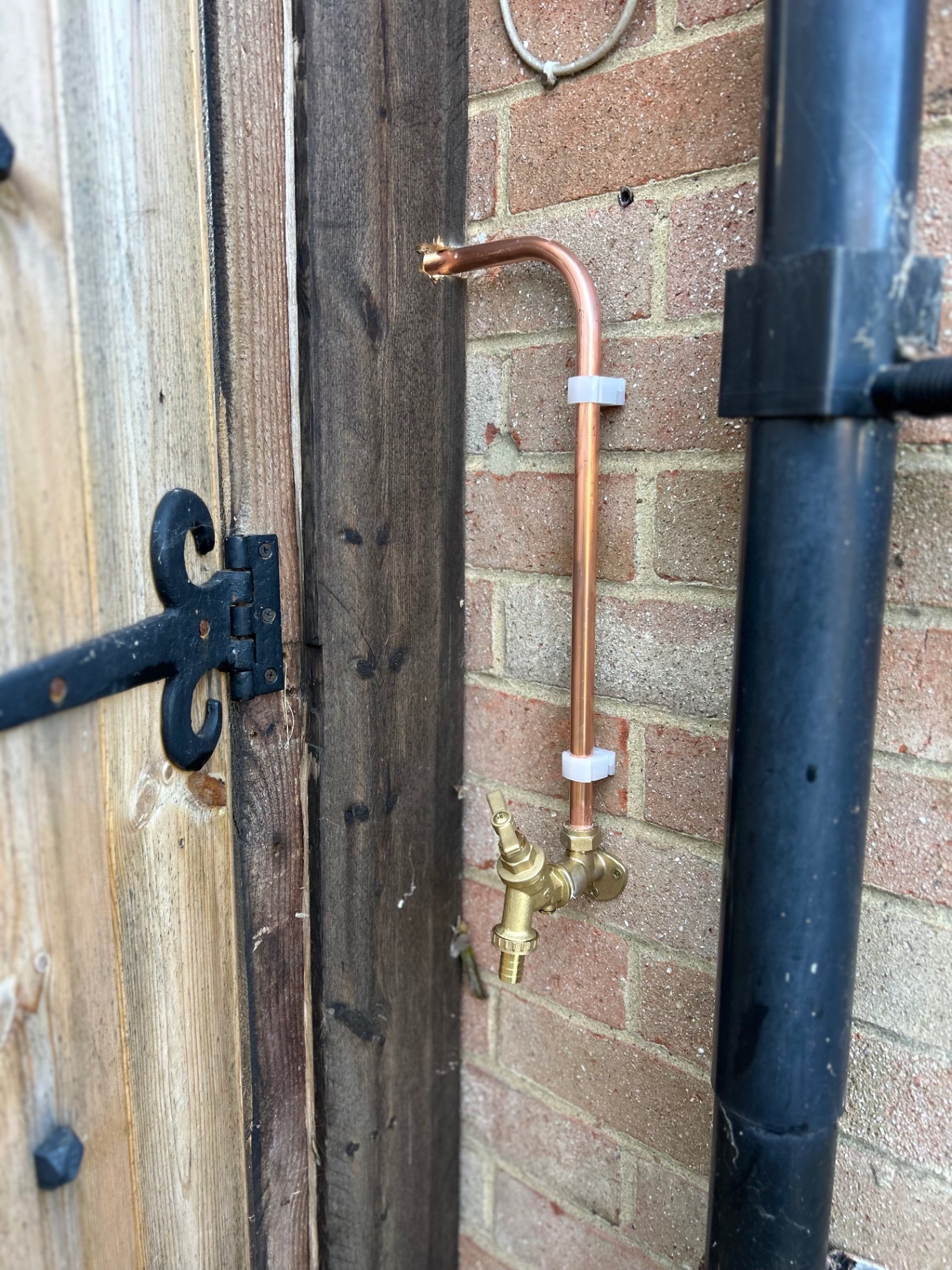 New outside tap with copper supply pipe fitted to a garden wall